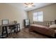 Cozy bedroom with wood laminate flooring, ceiling fan, and a comfortable bed at 10346 E Desert Dawn Dr, Gold Canyon, AZ 85118