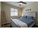 Serene bedroom featuring a whitewashed wood bed frame, ladder accent, and ample natural light at 10346 E Desert Dawn Dr, Gold Canyon, AZ 85118