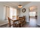Dining area with hardwood floors, neutral wall color, chandelier, and a full-size dining table at 10346 E Desert Dawn Dr, Gold Canyon, AZ 85118
