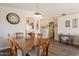 Charming dining area showcasing a wooden table set, leading into an arched doorway to other living spaces at 10346 E Desert Dawn Dr, Gold Canyon, AZ 85118