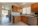 Open kitchen concept showing wooden cabinets, granite countertops, and a seamless flow into the dining area at 10346 E Desert Dawn Dr, Gold Canyon, AZ 85118