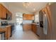 Modern kitchen featuring stainless steel appliances, wooden cabinets, and a glimpse of the backyard pool area at 10346 E Desert Dawn Dr, Gold Canyon, AZ 85118