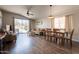 Bright living room with sliding glass doors, wood floors, and a comfortable seating arrangement perfect for relaxation at 10346 E Desert Dawn Dr, Gold Canyon, AZ 85118