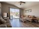 Living room with sliding glass doors leading to an outdoor patio and pool area, wood floors at 10346 E Desert Dawn Dr, Gold Canyon, AZ 85118