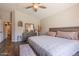 Cozy bedroom with wood-look floors, ceiling fan, and a dresser with decor at 10346 E Desert Dawn Dr, Gold Canyon, AZ 85118