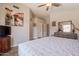 Cozy bedroom with wood-look floors, ceiling fan, and a dresser with decor at 10346 E Desert Dawn Dr, Gold Canyon, AZ 85118