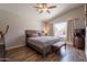 Comfortable main bedroom featuring a ceiling fan, and a window view of the pool at 10346 E Desert Dawn Dr, Gold Canyon, AZ 85118