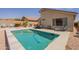 Backyard with a pool, patio furniture, and desert landscaping, creating a relaxing outdoor space at 10346 E Desert Dawn Dr, Gold Canyon, AZ 85118