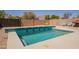 Backyard pool surrounded by a concrete patio, and desert landscaping perfect for enjoying outdoor living at 10346 E Desert Dawn Dr, Gold Canyon, AZ 85118