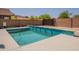 Backyard pool with decorative blue tile, concrete surround, and privacy fence, a serene outdoor retreat at 10346 E Desert Dawn Dr, Gold Canyon, AZ 85118