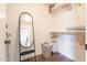 Organized walk-in closet with ample shelving, wood-look floors, and a full-length mirror at 10346 E Desert Dawn Dr, Gold Canyon, AZ 85118