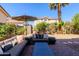 Inviting backyard with patio seating, lush landscaping, palm tree, gravel beds and grass at 1145 E Lowell Ave, Gilbert, AZ 85295