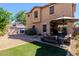 Inviting backyard with patio seating, manicured lawn, gravel beds, and exterior of home at 1145 E Lowell Ave, Gilbert, AZ 85295