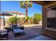 Inviting backyard with patio seating, lush landscaping, palm tree, gravel beds and grass at 1145 E Lowell Ave, Gilbert, AZ 85295