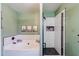Bright bathroom featuring a tub and separate shower with white subway tile and black fixtures at 1145 E Lowell Ave, Gilbert, AZ 85295
