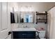 Full bathroom with stylish vanity, framed mirror, open shelving, and shower with tub at 1145 E Lowell Ave, Gilbert, AZ 85295