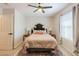 Comfortable bedroom featuring a ceiling fan, a queen-sized bed and a view from the window at 1145 E Lowell Ave, Gilbert, AZ 85295