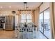 Bright dining area with pendant lighting and sliding glass doors to outdoor patio at 1145 E Lowell Ave, Gilbert, AZ 85295
