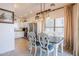 Charming dining area boasts a unique light fixture, stainless steel appliances, and light cabinetry at 1145 E Lowell Ave, Gilbert, AZ 85295