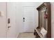 Well-organized entryway featuring a coat rack and storage bench, combining style with functionality in a bright space at 1145 E Lowell Ave, Gilbert, AZ 85295