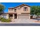 Charming two-story home featuring a neutral color scheme, attached two-car garage, and well-maintained landscaping at 1145 E Lowell Ave, Gilbert, AZ 85295