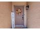Charming front door adorned with a wreath and decorative sign, welcoming guests to a cozy home at 1145 E Lowell Ave, Gilbert, AZ 85295