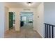 Hallway upstairs featuring carpet, doorway to a living room, and doorway to a bedroom at 1145 E Lowell Ave, Gilbert, AZ 85295