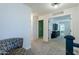 Upstairs hallway with chair, carpet, and entryways to other bedrooms and living areas at 1145 E Lowell Ave, Gilbert, AZ 85295
