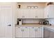 Kitchen featuring white cabinets, modern appliances, countertop, mosaic backsplash, and breakfast nook at 1145 E Lowell Ave, Gilbert, AZ 85295