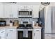 Updated kitchen includes stainless steel appliances, modern backsplash, and stylish cabinetry at 1145 E Lowell Ave, Gilbert, AZ 85295