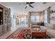 Comfortable living room featuring neutral tones, a ceiling fan, and a decorative area rug at 1145 E Lowell Ave, Gilbert, AZ 85295