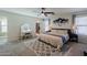 Spacious main bedroom with fan, vanity, large rug, walk-in closet, and natural light at 1145 E Lowell Ave, Gilbert, AZ 85295