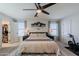 Comfortable main bedroom featuring fan, large bed, and decor, including walk-in closet at 1145 E Lowell Ave, Gilbert, AZ 85295