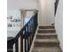 Carpeted staircase featuring dark wood railing, natural light, and easy access to the upper level at 1145 E Lowell Ave, Gilbert, AZ 85295