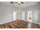 Bright bedroom with wood-look floors and double doors leading to other rooms at 12441 W Windsor Blvd, Litchfield Park, AZ 85340