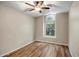 Bedroom with wood-look floors, a ceiling fan, and an arched window at 12441 W Windsor Blvd, Litchfield Park, AZ 85340