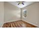 Cozy bedroom with wood-look floors, a ceiling fan, and a window for natural light at 12441 W Windsor Blvd, Litchfield Park, AZ 85340