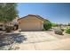 Inviting single-Gathering home featuring a two-car garage, desert landscaping, and a concrete driveway at 12441 W Windsor Blvd, Litchfield Park, AZ 85340