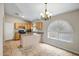 Eat-in kitchen features granite countertops, wood cabinets, and tile flooring with bright, natural lighting at 12441 W Windsor Blvd, Litchfield Park, AZ 85340