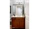 Bathroom vanity showcasing wood cabinets, white countertop, and a decorative mirror at 13300 E Via Linda Dr # 1058, Scottsdale, AZ 85259