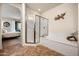 Bathroom showcasing a glass-enclosed shower, separate bathtub, and decorative wall art at 13300 E Via Linda Dr # 1058, Scottsdale, AZ 85259