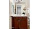 Bathroom vanity featuring wood cabinets, white countertop, and decorative mirror at 13300 E Via Linda Dr # 1058, Scottsdale, AZ 85259