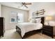 Comfortable bedroom features a ceiling fan, neutral decor, and side tables with lamps at 13300 E Via Linda Dr # 1058, Scottsdale, AZ 85259