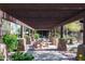 Shaded pergola area with picnic tables and lush landscaping provides a relaxing outdoor experience at 13300 E Via Linda Dr # 1058, Scottsdale, AZ 85259
