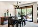 Elegant dining room featuring a contemporary chandelier and sliding glass door to the outdoors at 13300 E Via Linda Dr # 1058, Scottsdale, AZ 85259