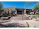 Southwestern-style building with multiple stories and beautiful outdoor stairs with mature desert landscaping at 13300 E Via Linda Dr # 1058, Scottsdale, AZ 85259