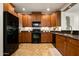 Well-equipped kitchen features stainless steel appliances and wooden cabinets with granite countertops at 13300 E Via Linda Dr # 1058, Scottsdale, AZ 85259