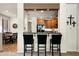 Modern kitchen view showcases a breakfast bar with granite countertops and wooden cabinetry at 13300 E Via Linda Dr # 1058, Scottsdale, AZ 85259