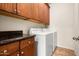 Laundry room with full size washer and dryer, with upper cabinets for extra storage at 13300 E Via Linda Dr # 1058, Scottsdale, AZ 85259