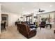 Open-concept living room features leather furniture, ceiling fan, with a window view at 13300 E Via Linda Dr # 1058, Scottsdale, AZ 85259